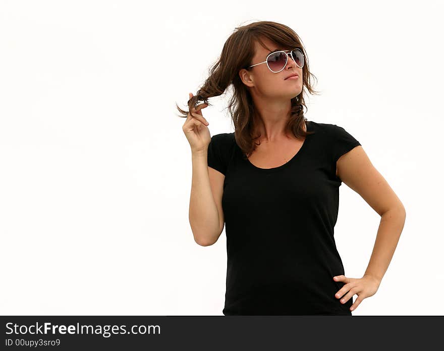 - a model posing against a light grey sky (almost white) and twisting her hair. - a model posing against a light grey sky (almost white) and twisting her hair