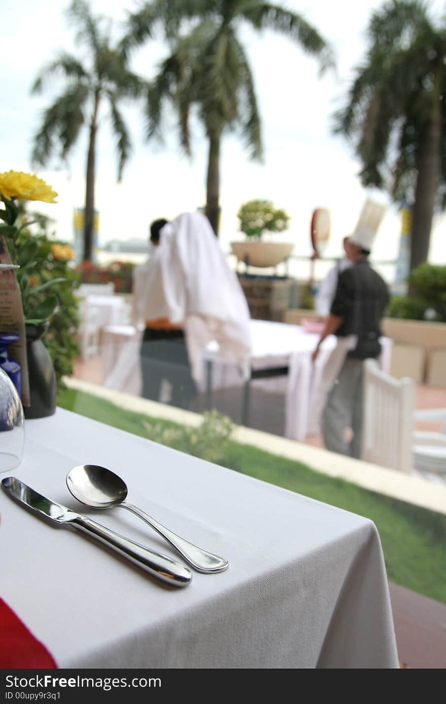 Photograph of restaurant table with staff busy at background