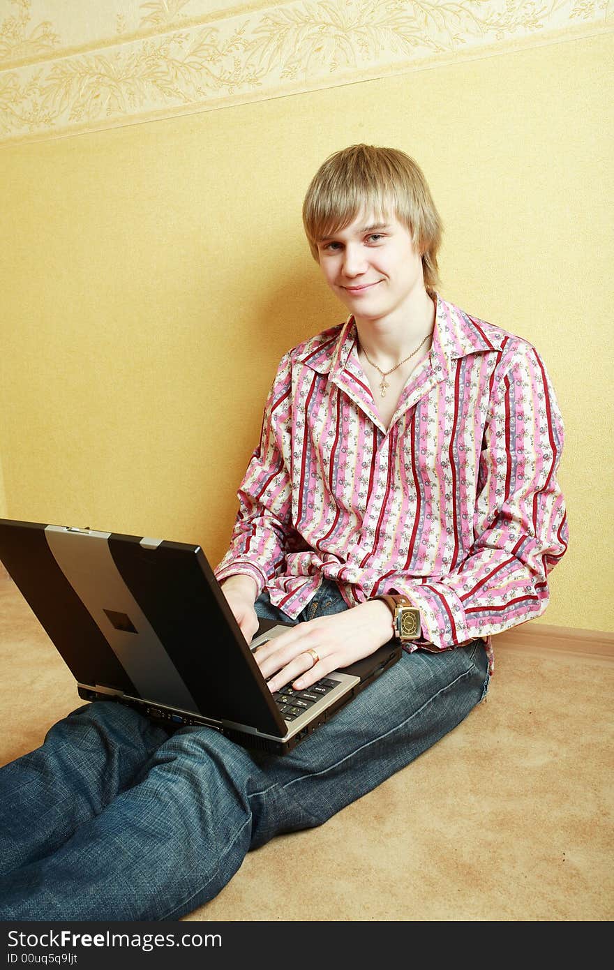 Young stylish man home with laptop. Young stylish man home with laptop