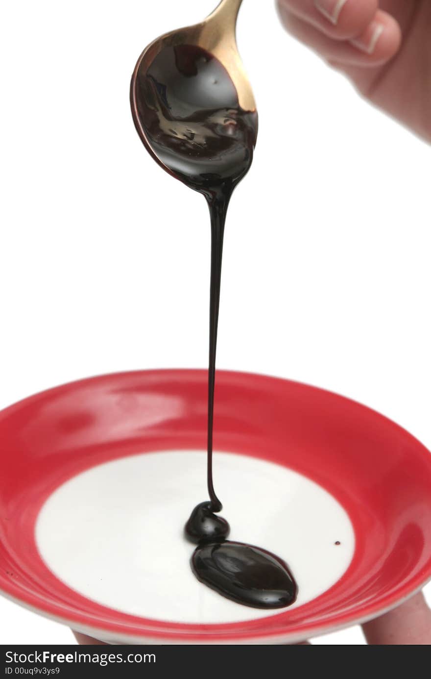 Drops Of Chocolate On The Spoon And A Plate