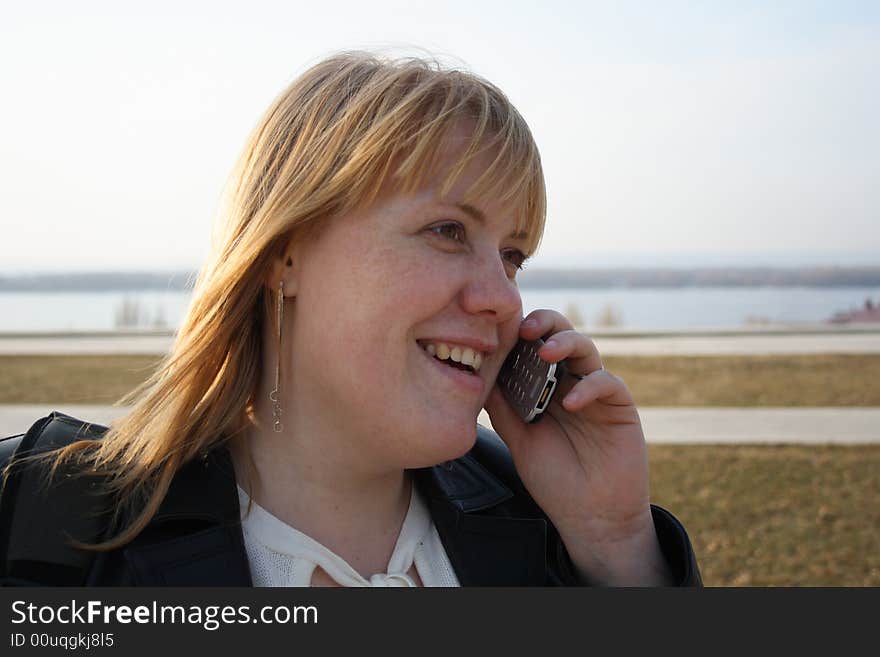 Pretty young girl talking on cell phone outdoor. Pretty young girl talking on cell phone outdoor