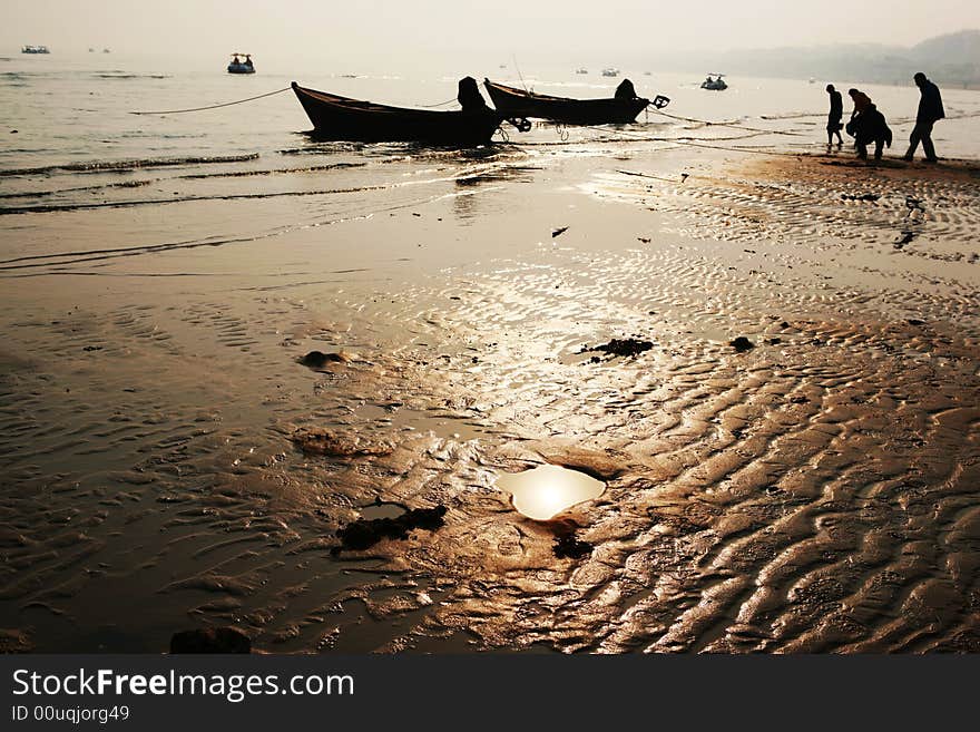 The picture was taken in Beidaihe,it sets on the coast some 280km east of beijing.The tide was on the ebb, people were walking on the beach. The picture was taken in Beidaihe,it sets on the coast some 280km east of beijing.The tide was on the ebb, people were walking on the beach.