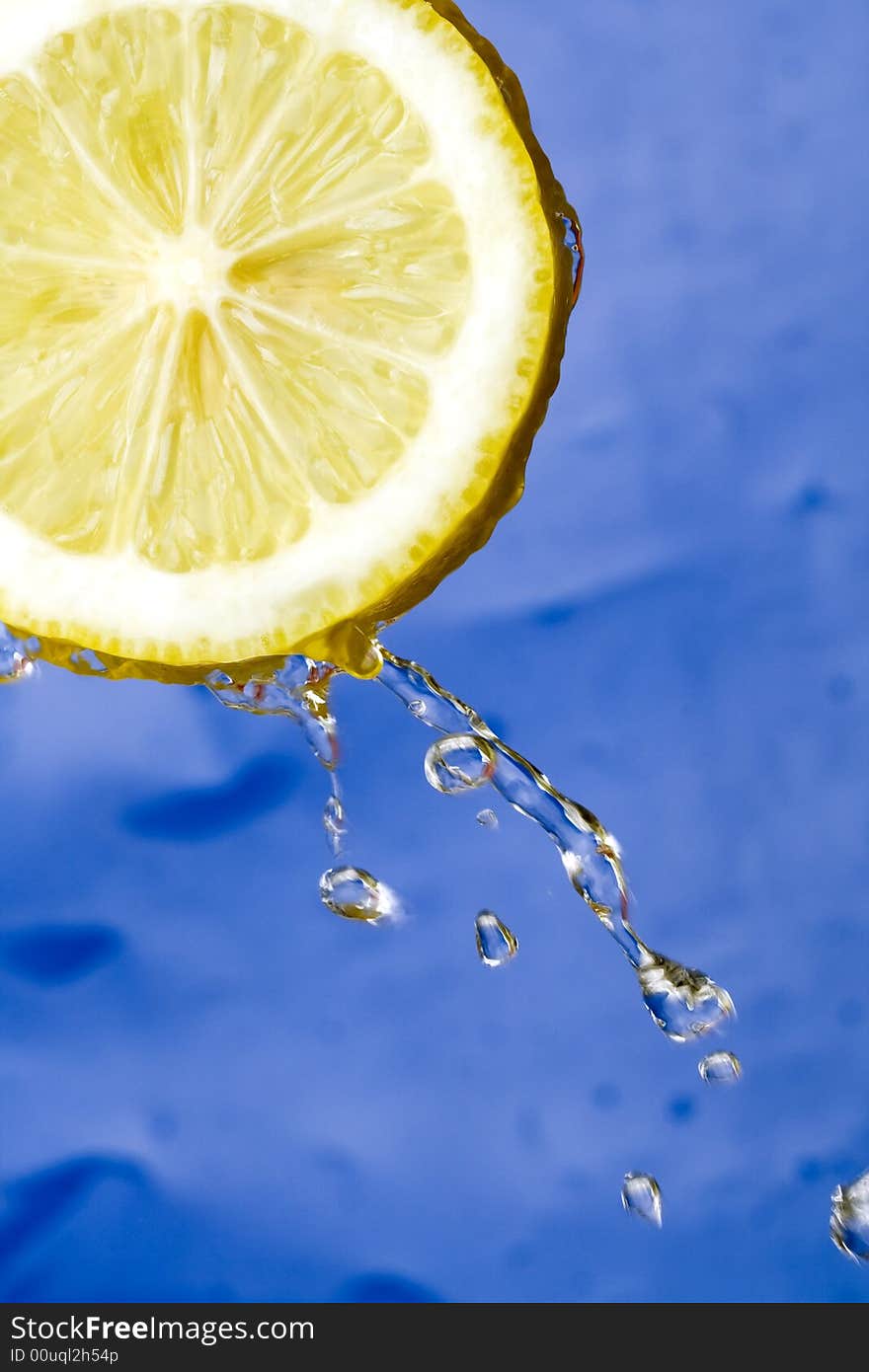 Yellow refreshing lemon against the blue background