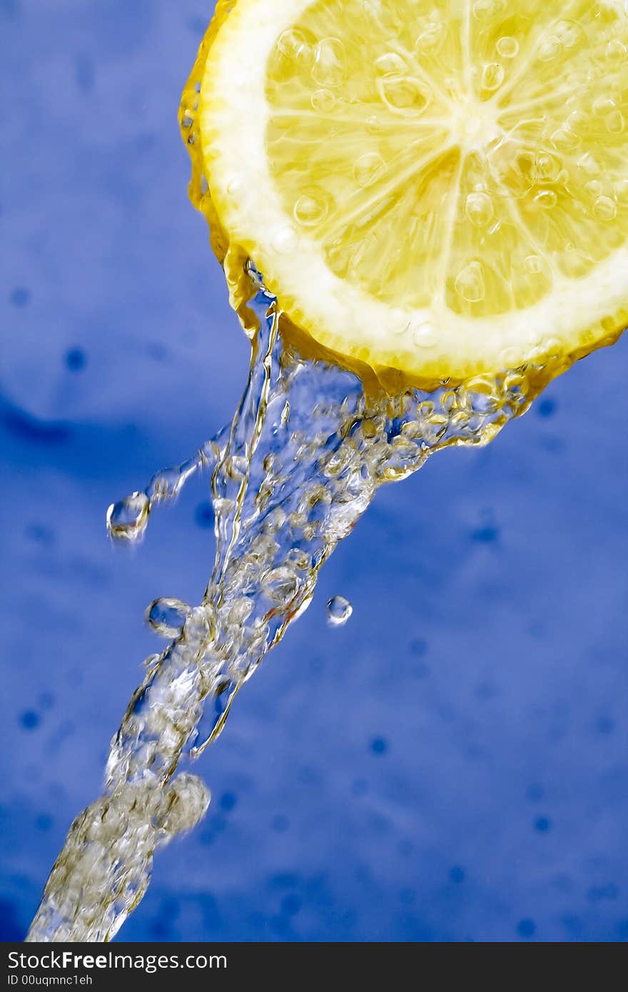 Yellow refreshing lemon against the blue background