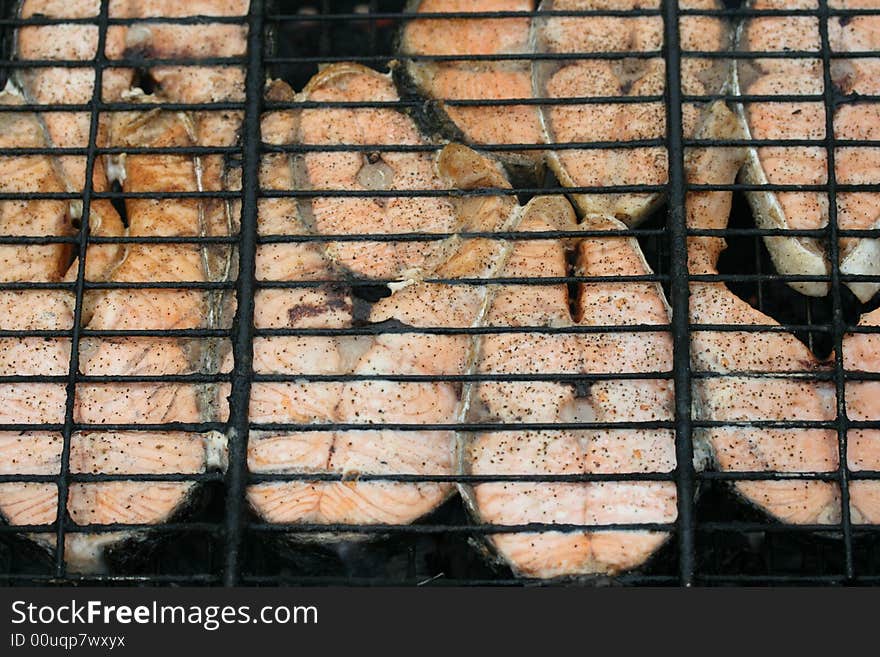 Close-up of grilled salmon pieces (background)