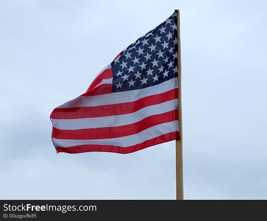 The flag of the USA on the background of the blue sky