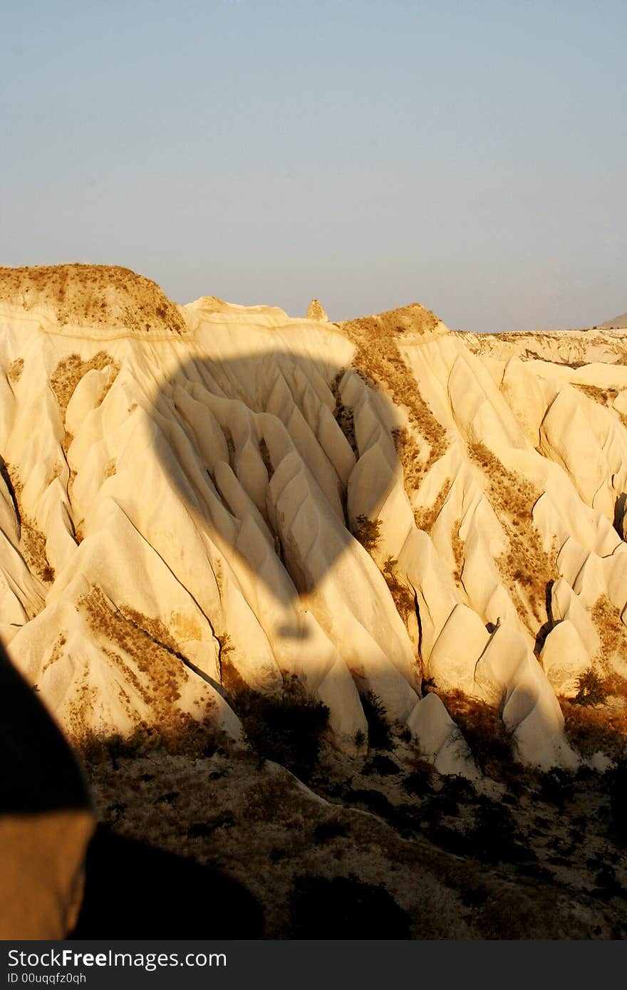 Shadow of balloon drifting across rock formation in cappadocia. Shadow of balloon drifting across rock formation in cappadocia