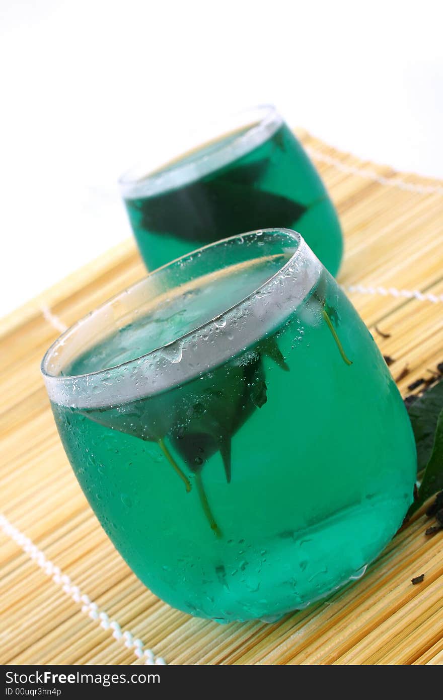 Dry leaves of green tea on white background