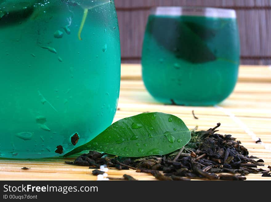 Dry leaves of green tea on white background