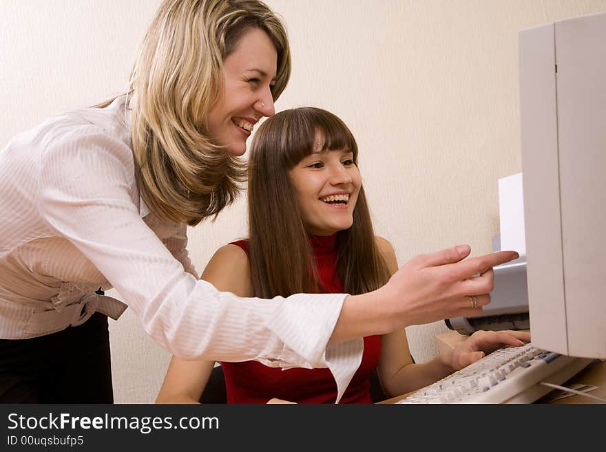 Joyful businesswomen at office looking at computer screen