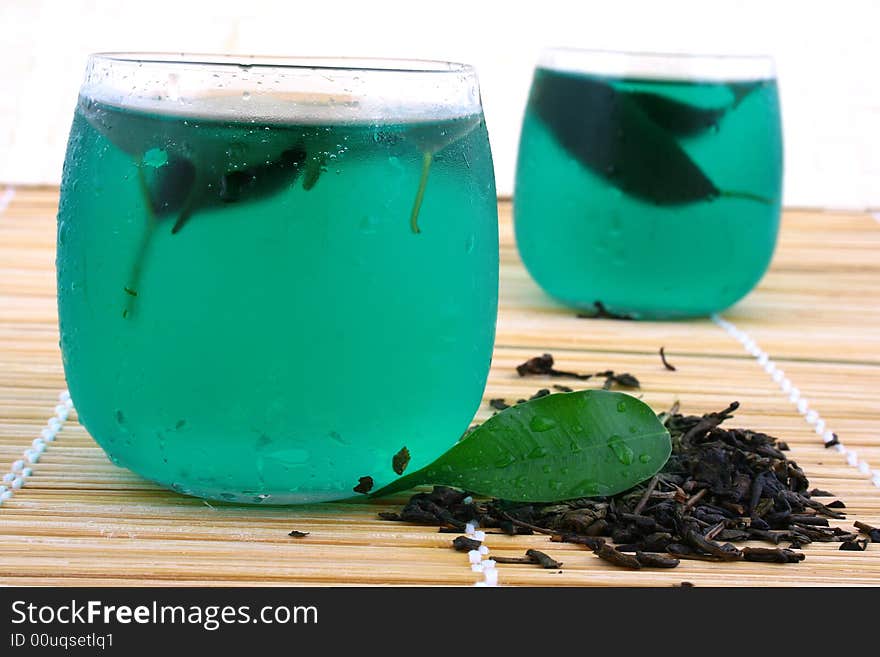 Dry leaves of green tea on white background