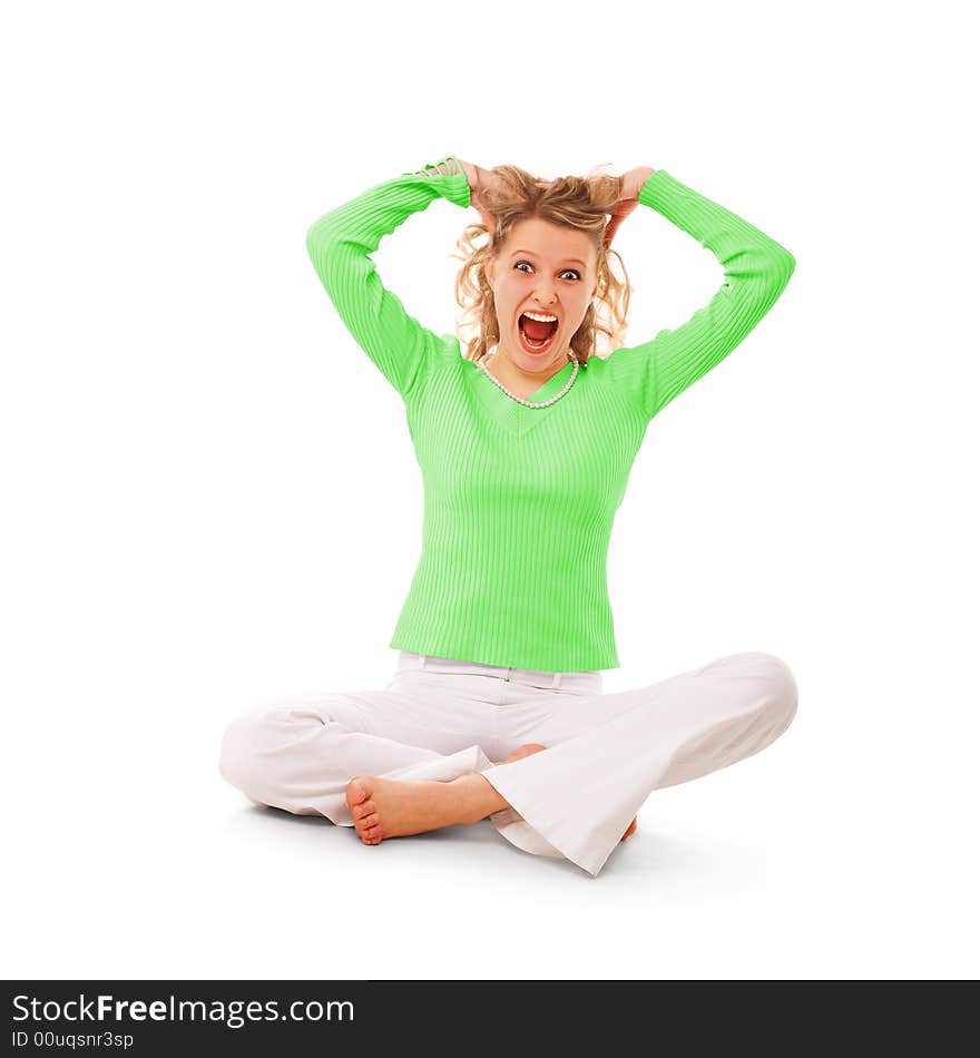 Beauty screaming girl seating on floor over white background. Beauty screaming girl seating on floor over white background