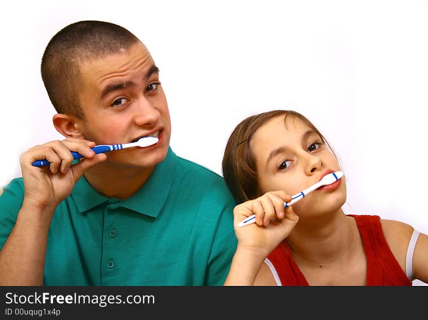 Brother and sister clean a teeth.