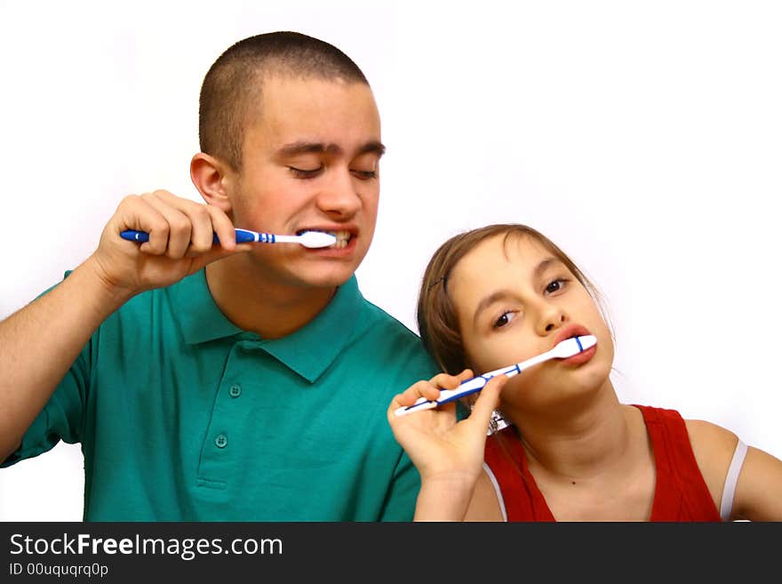 Brother and sister clean a teeth.