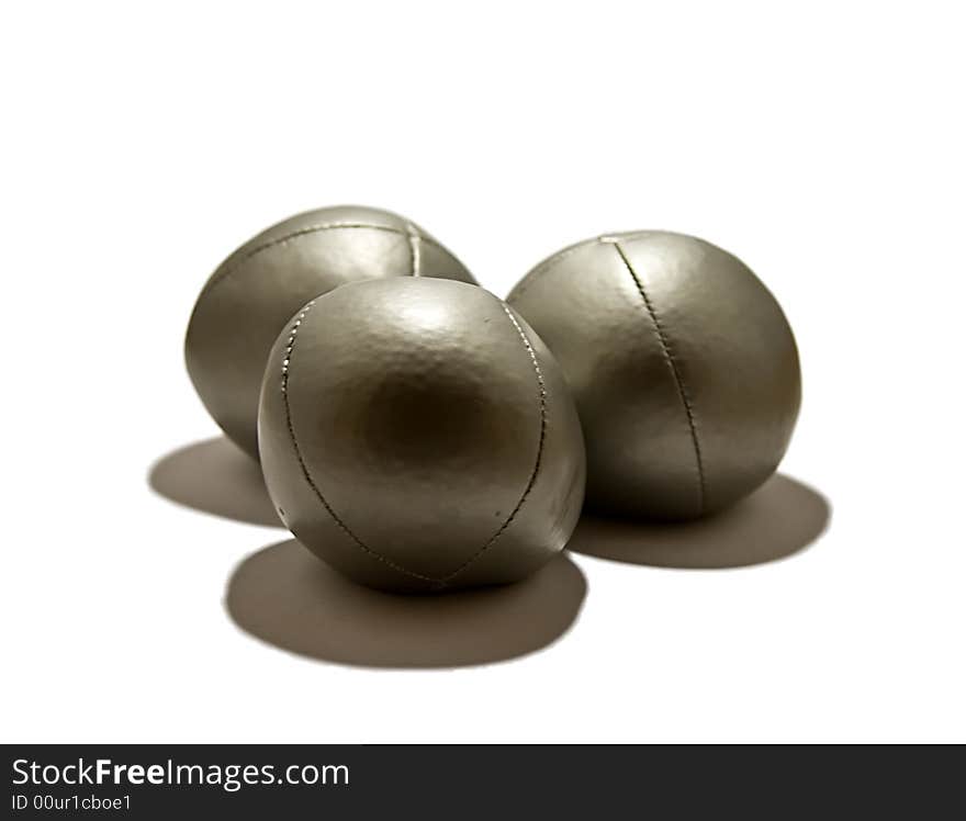 Three silver juggling balls on a white background.