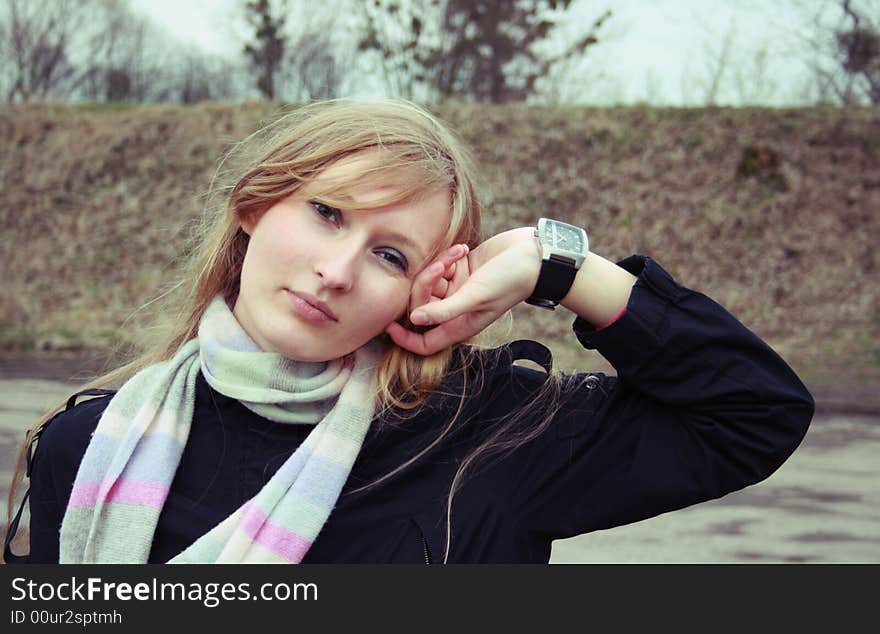 A girl in black with a watch on her hand. A girl in black with a watch on her hand