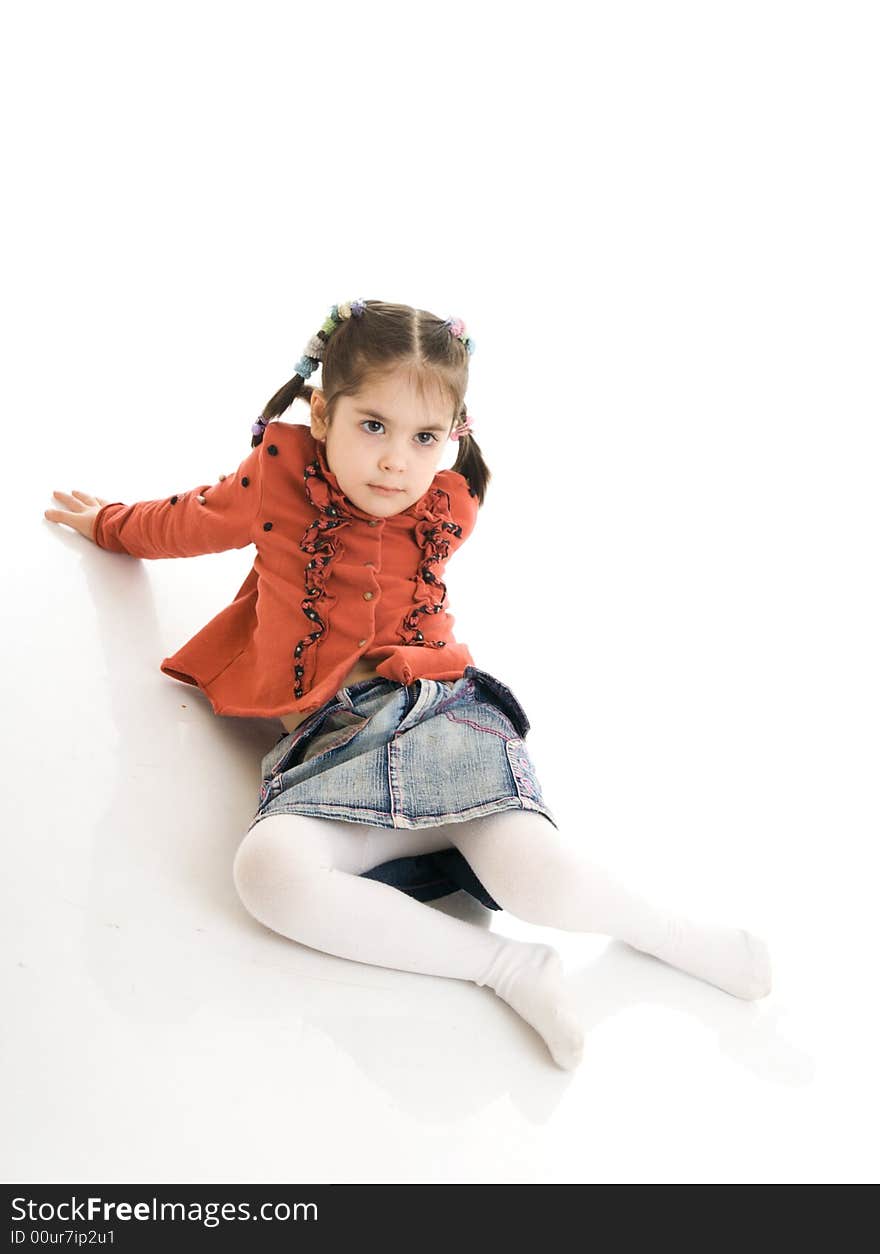 The little sitting girl isolated on a white background