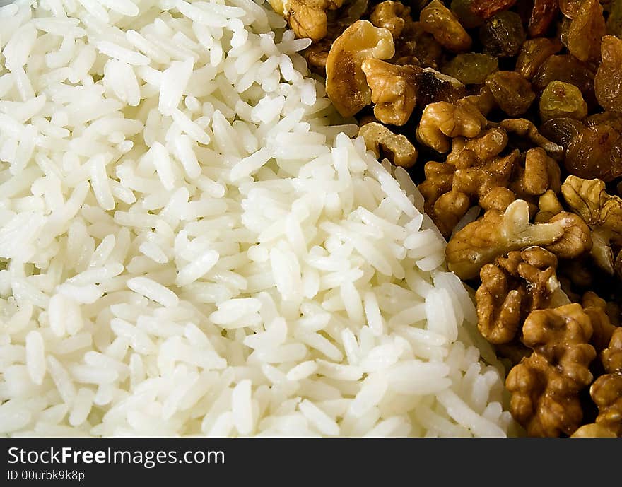 The image contains rice, nuts and raisin. The image contains rice, nuts and raisin