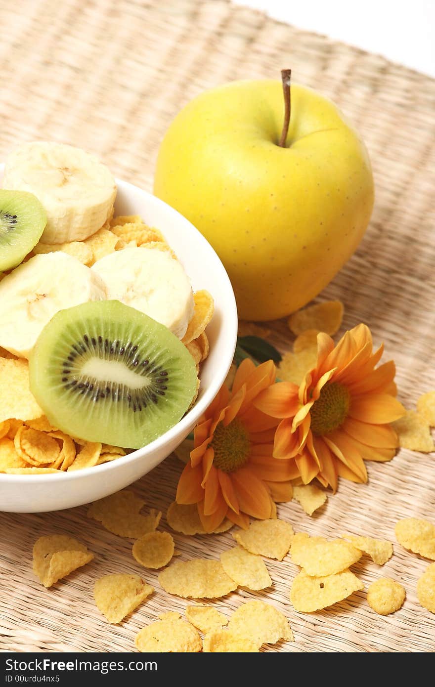 Healthy breakfast.Cornflakes and fruits with flowers. Healthy breakfast.Cornflakes and fruits with flowers.