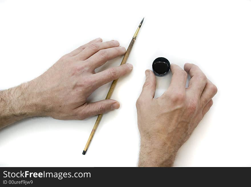 Artist's hands with the brush and ink