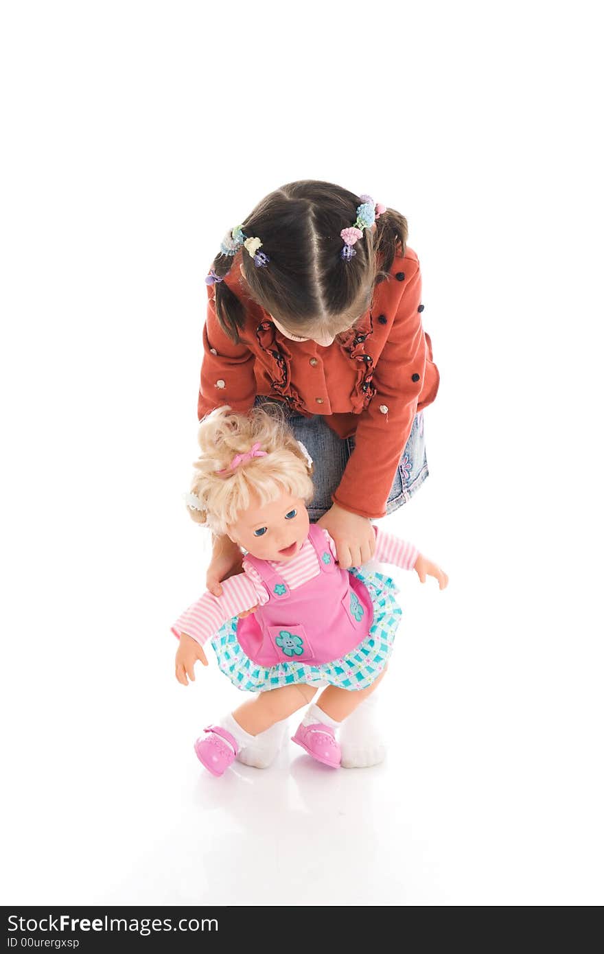 The little girl with a doll isolated on a white background