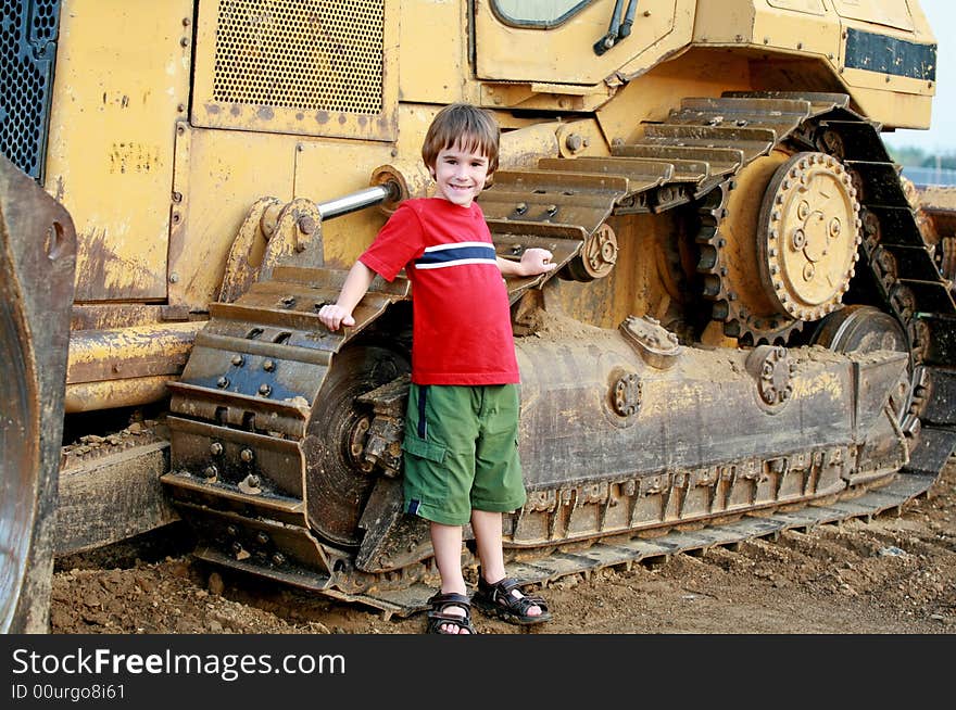 Little Boy in Leaning on a Bulldozer. Little Boy in Leaning on a Bulldozer