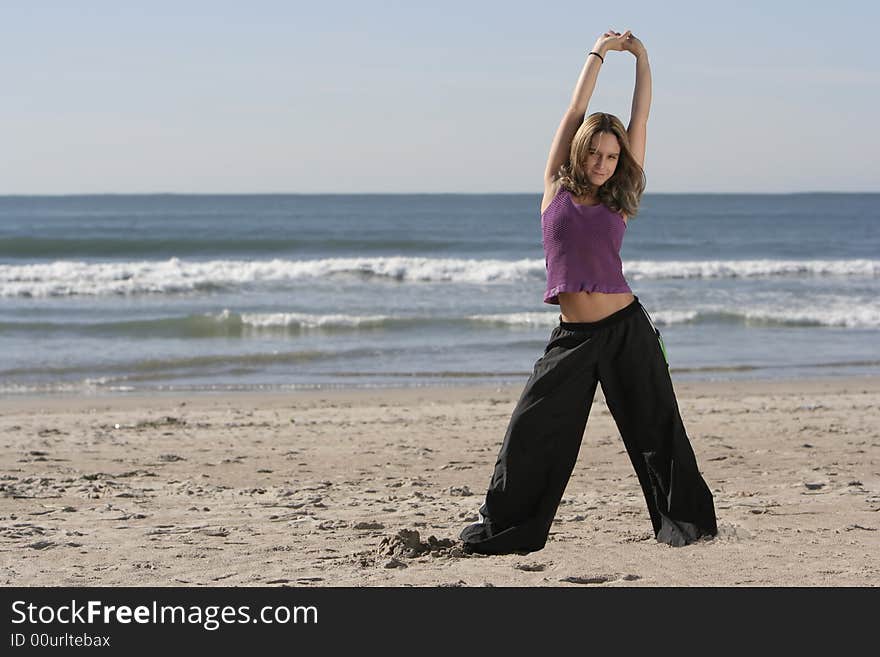 Woman stretching at the beach