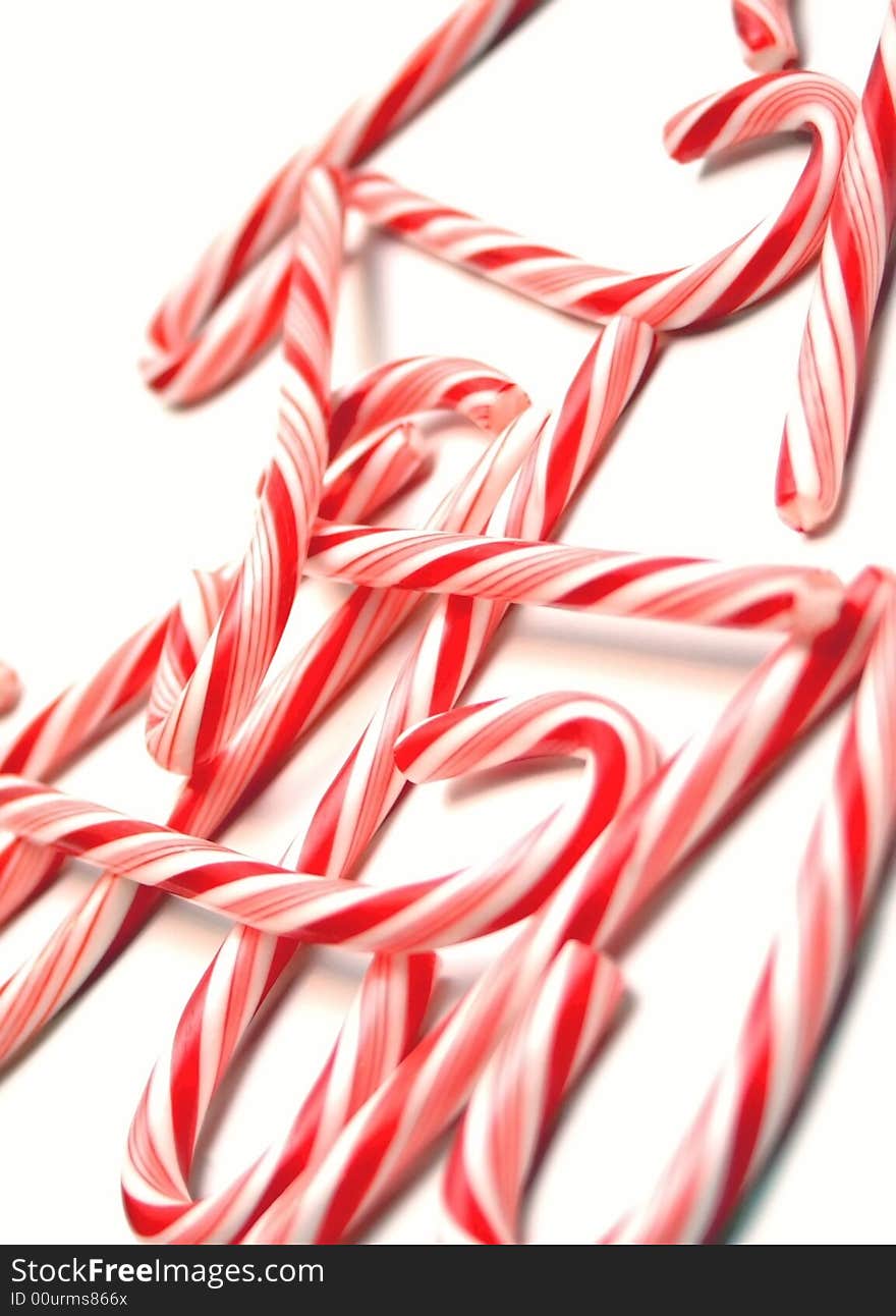 An array of candy canes scattered on a white background. An array of candy canes scattered on a white background