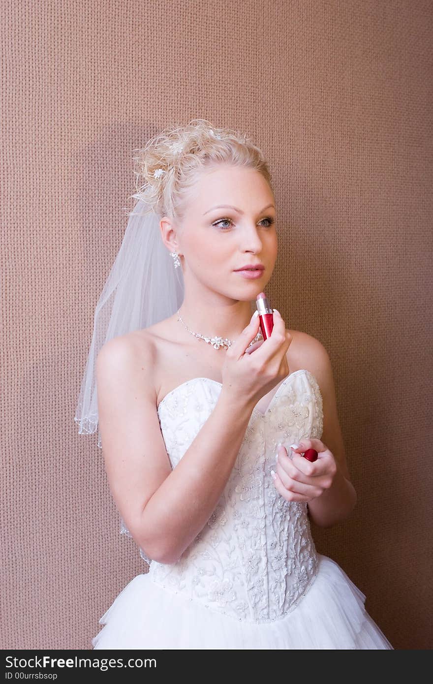 Bride painting her lips