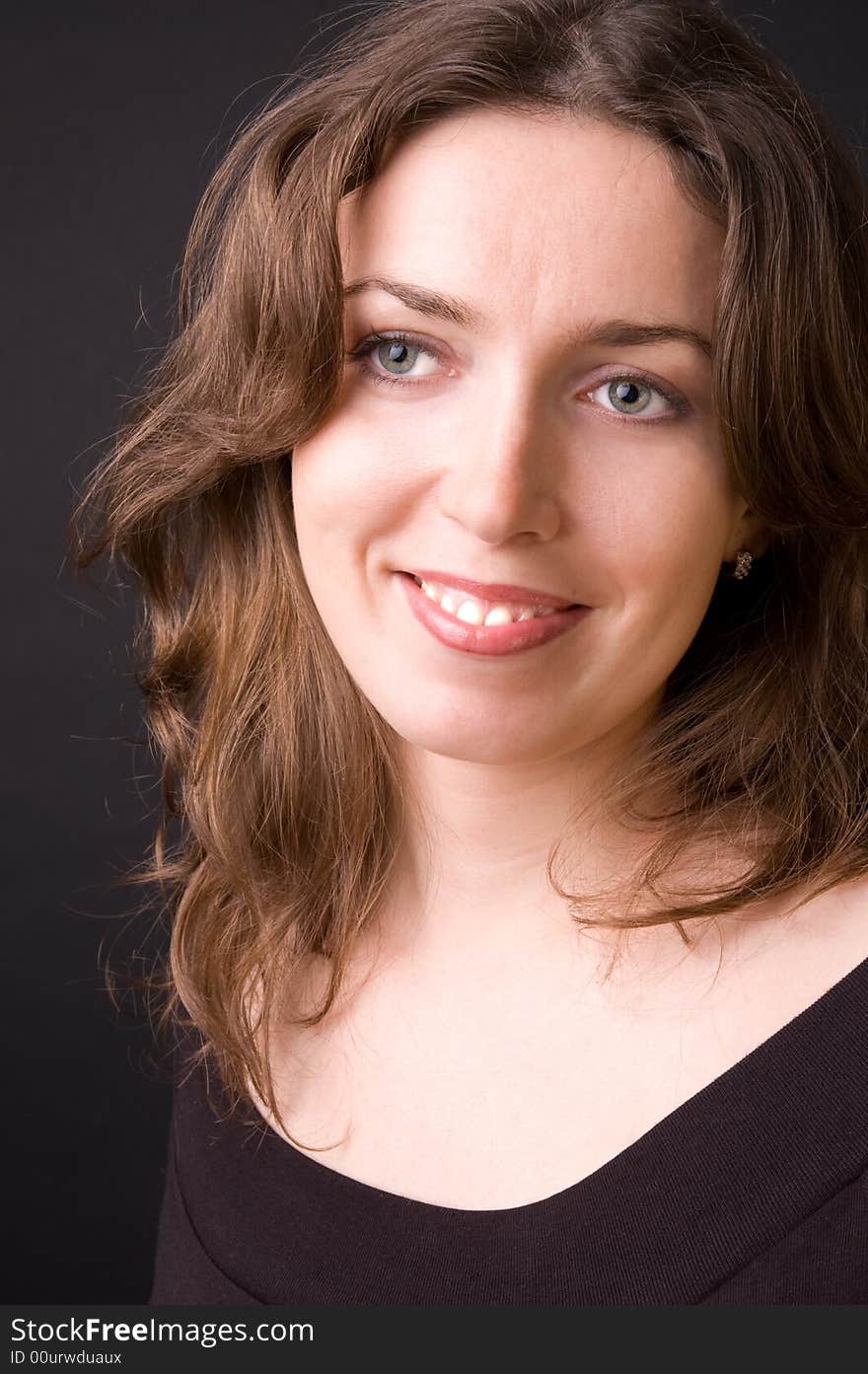 The beautiful girl in studio on a black background.