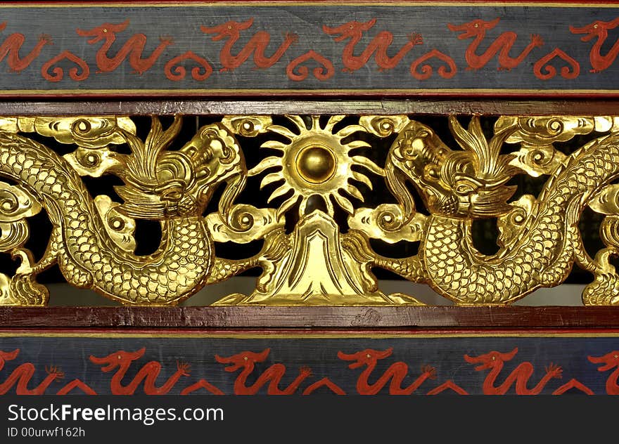 China; shangai; temple decor; traditional design for these wooden carved dragons in gold leaf