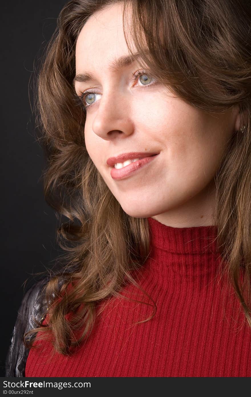 The beautiful girl in studio on a black background.