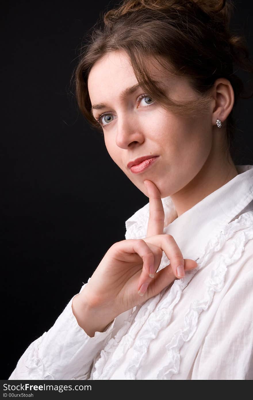 The beautiful girl in studio on a black background.