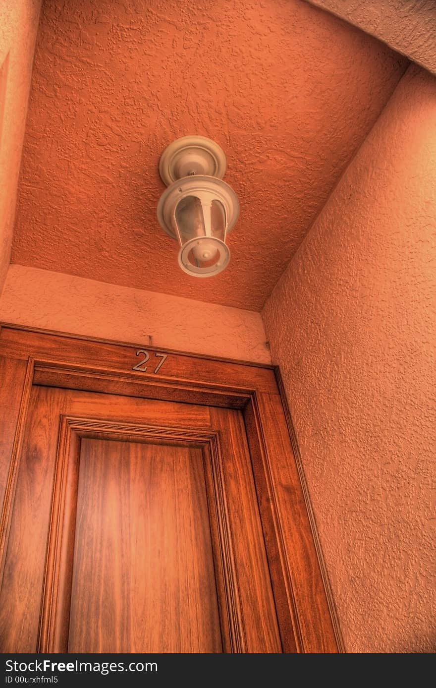 Light fixture over door in stucco entryway