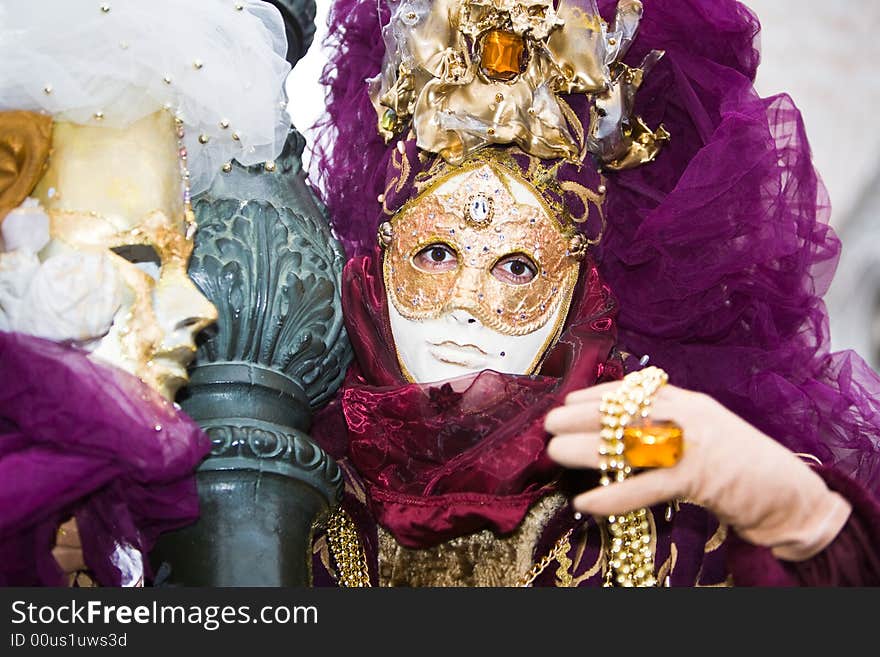 Gold and purple costume at the Venice Carnival. Gold and purple costume at the Venice Carnival