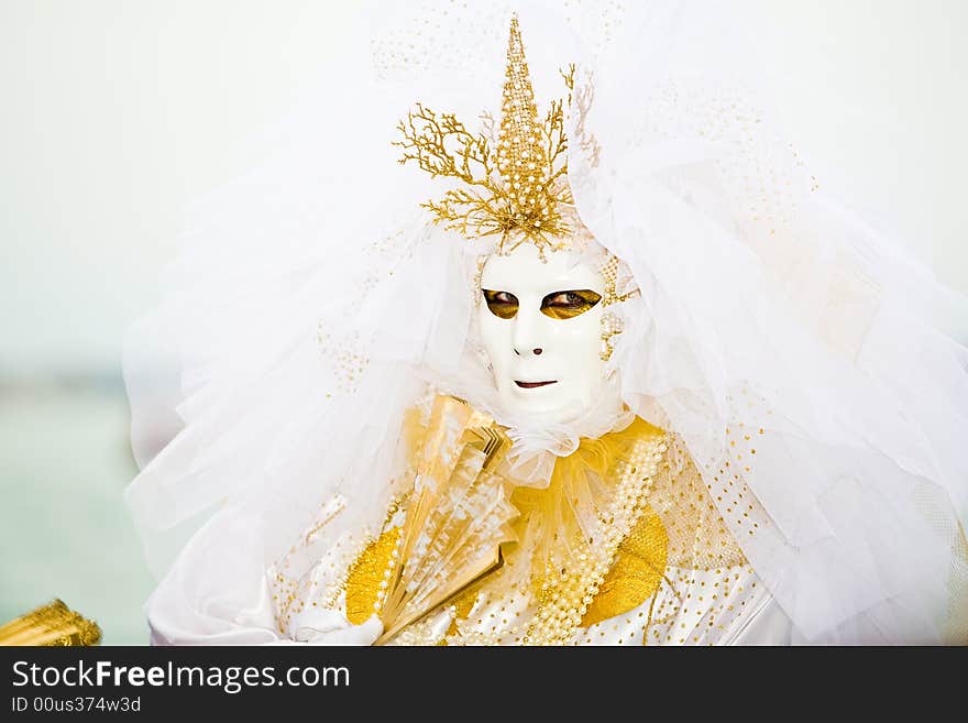 Gold and white costume at the Venice Carnival. Gold and white costume at the Venice Carnival