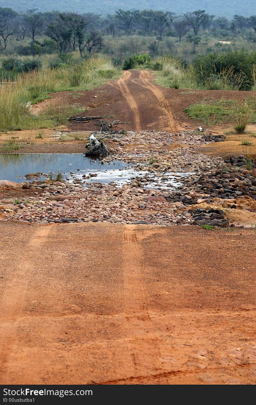 Dirt track crossing a stream within entabeni game reserve welgevonden waterberg limpopo province south africa