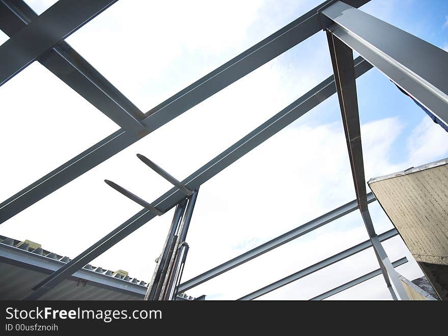 Forklift put the steel beam into the metal construction. Forklift put the steel beam into the metal construction