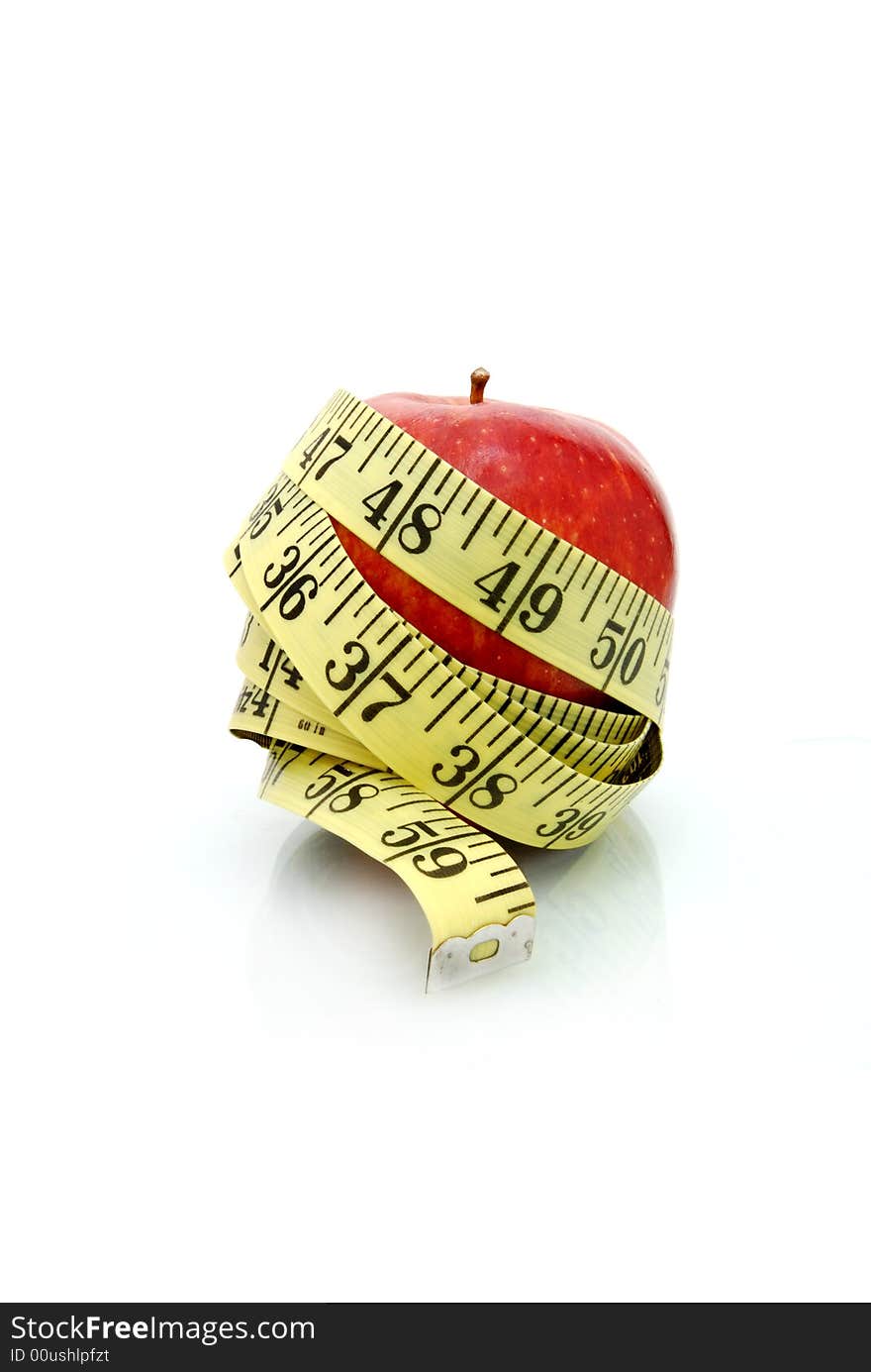 Apple wrapped in tape measure. Apple wrapped in tape measure