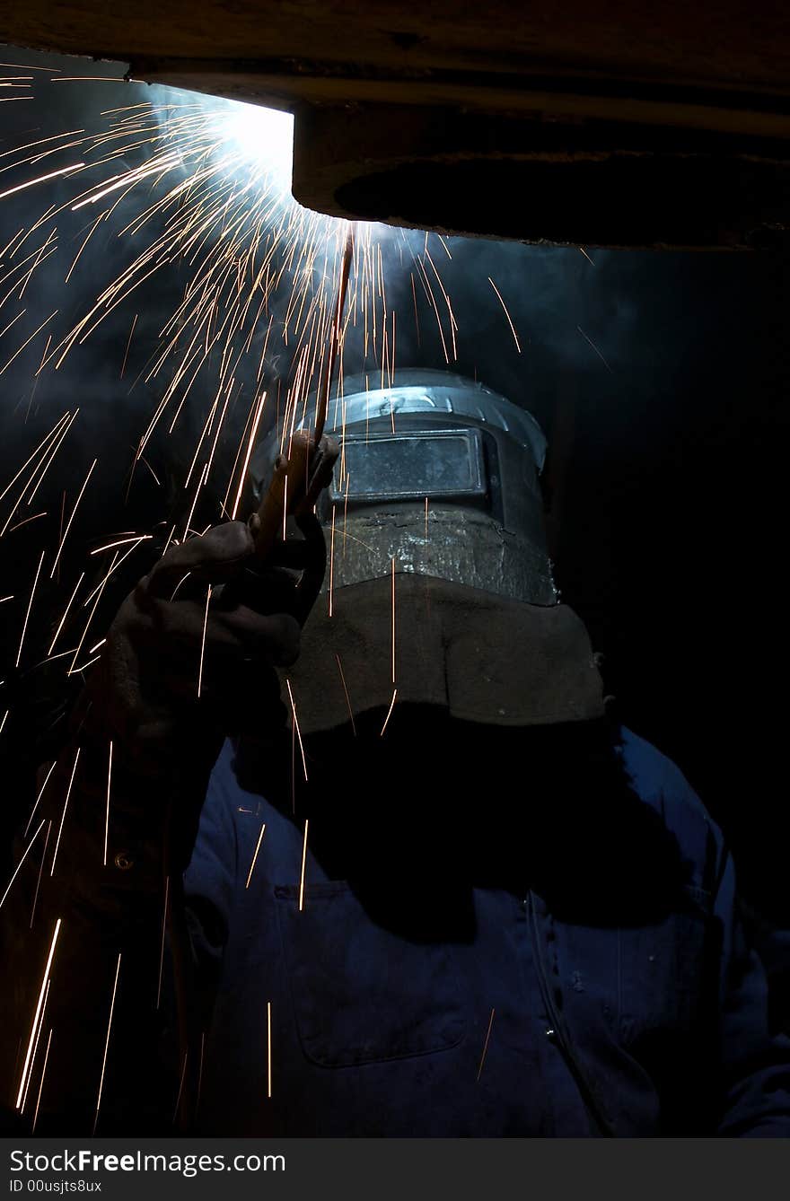 A welder working at shipyard at night. A welder working at shipyard at night