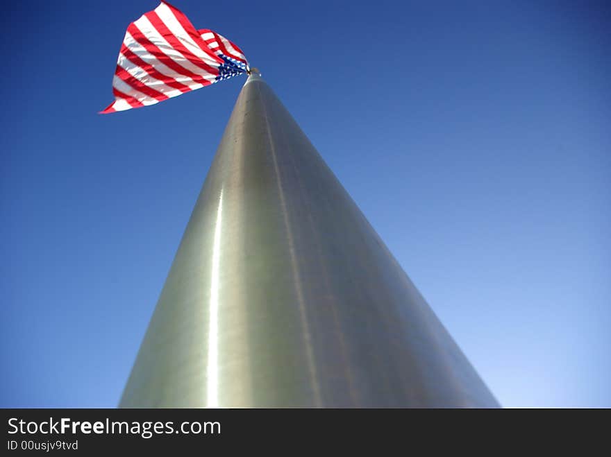 A unique view of a large American flag flying from the top of an aluminim flagpole. A unique view of a large American flag flying from the top of an aluminim flagpole.