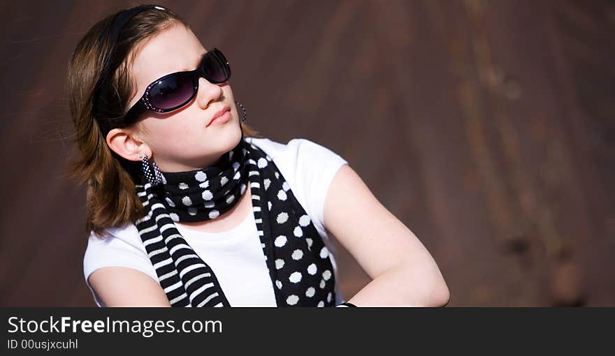 Head and Shoulders portrait of a preteen girl wearing sunglasses. Head and Shoulders portrait of a preteen girl wearing sunglasses.