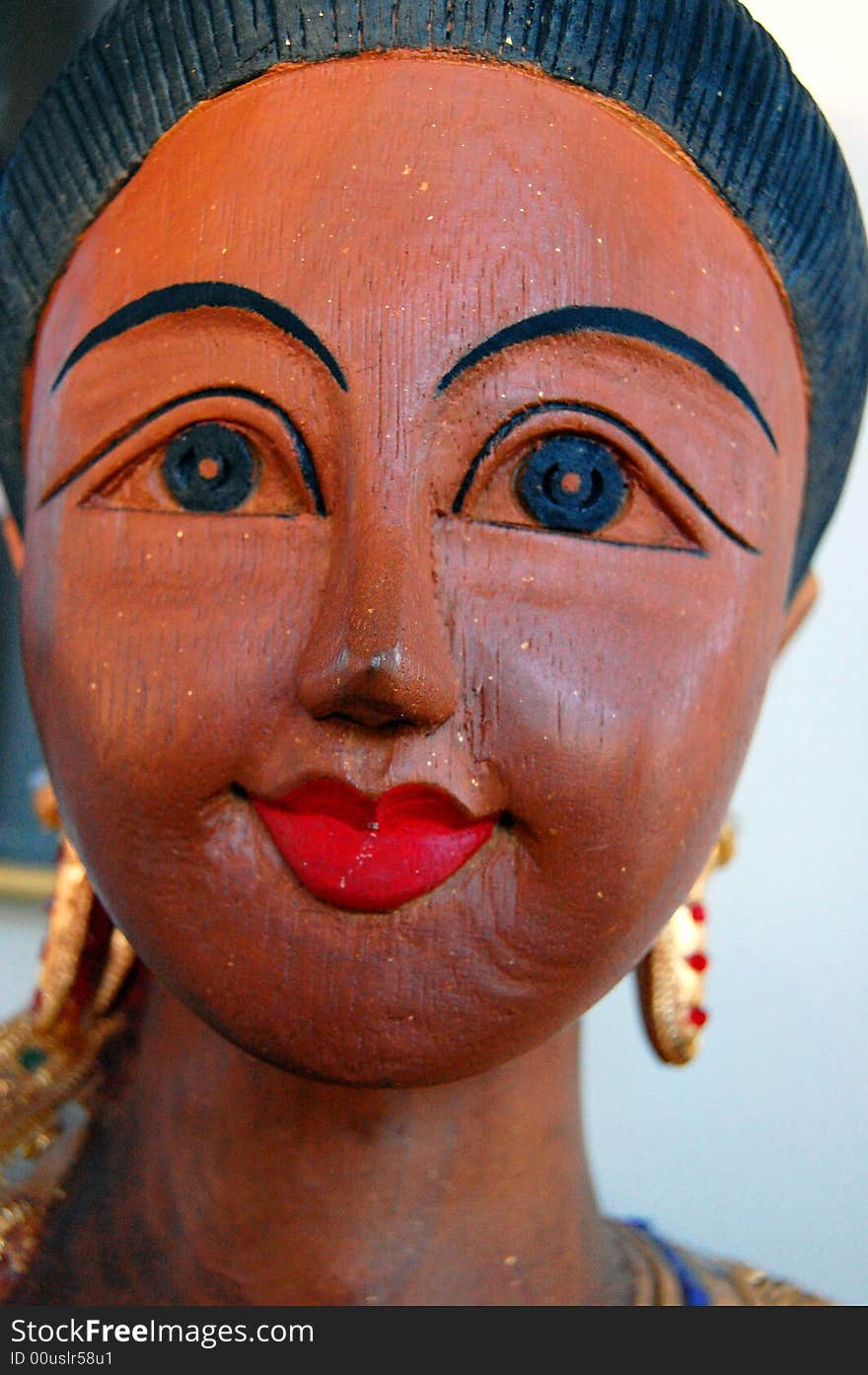 A wooden statue of a woman from Thailand. A wooden statue of a woman from Thailand.