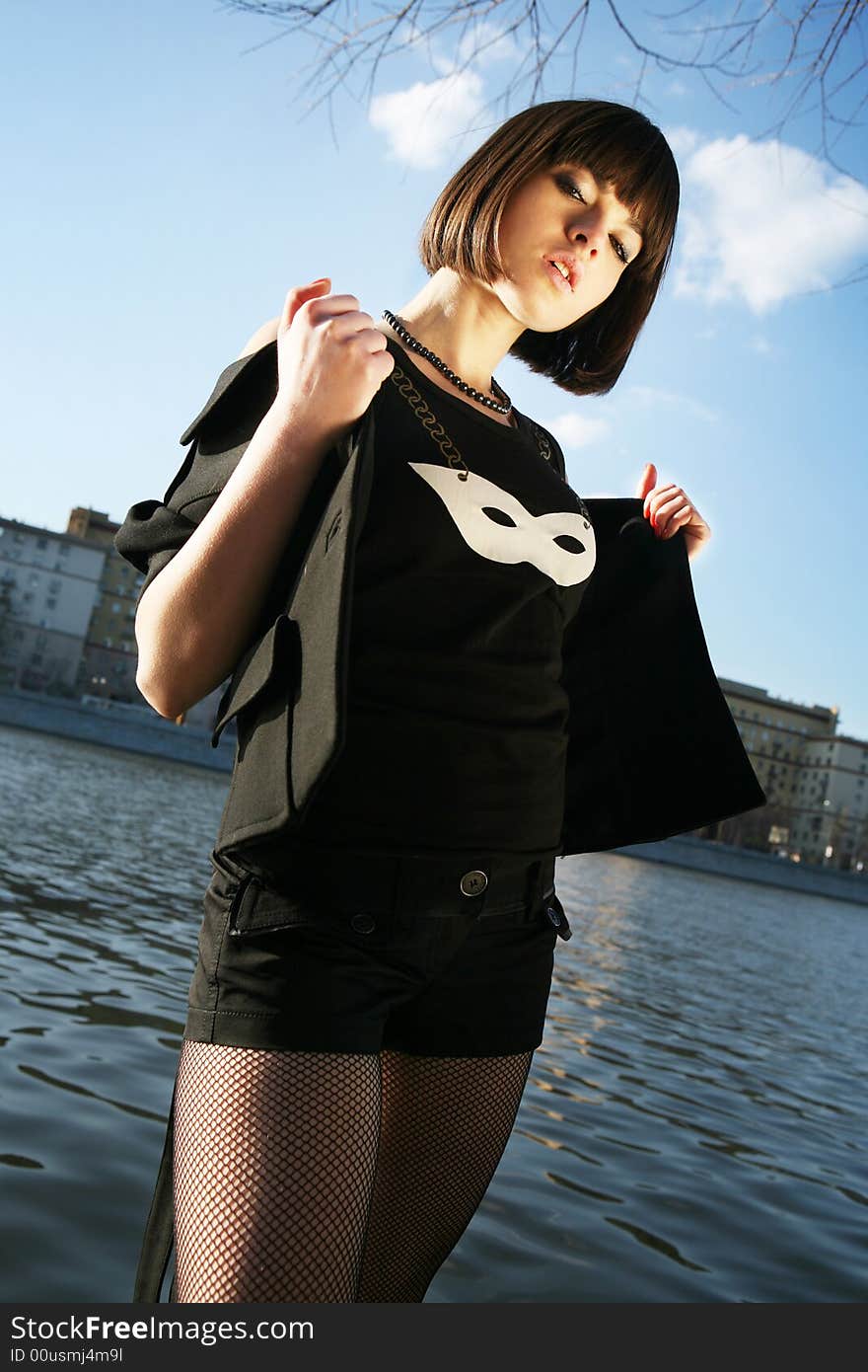 Young girl posing in fancy clothes by the river. Moscow city background. Young girl posing in fancy clothes by the river. Moscow city background