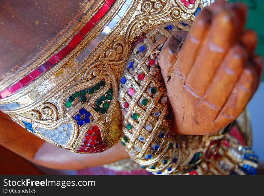 A close-up shot of the details on a statue carved of wood. A close-up shot of the details on a statue carved of wood.