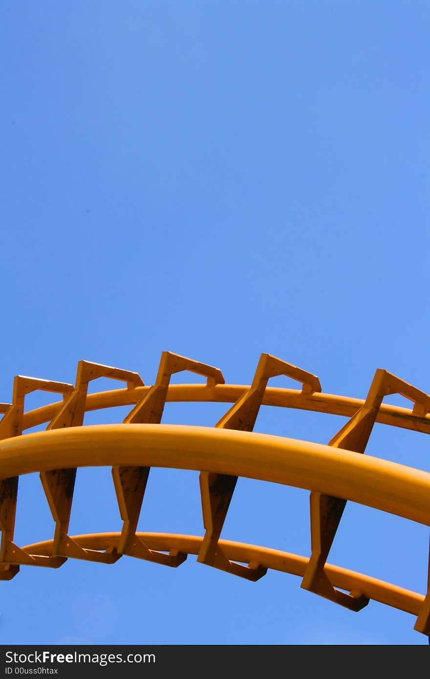 Track section of a yellow roller coaster. Track section of a yellow roller coaster