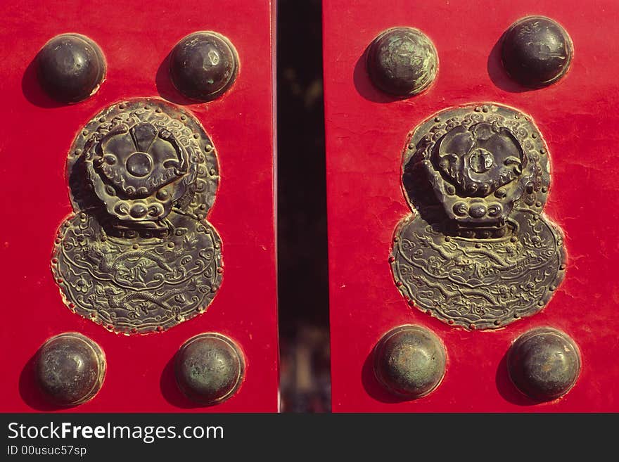 Knockers and doornails on a red door, the forbidden city, china