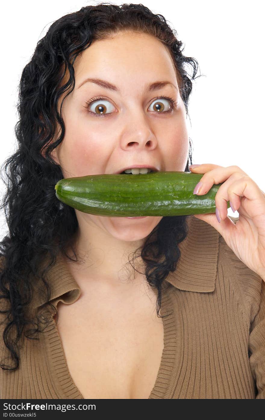 The beautiful girl bites a cucumber