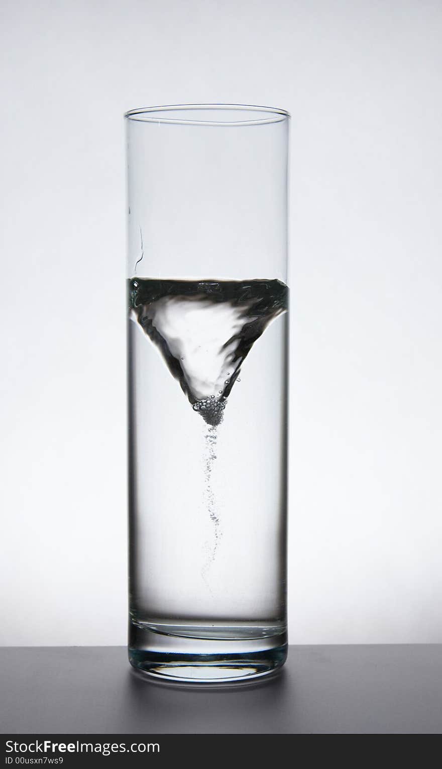 Funnel in a glass vase with water.