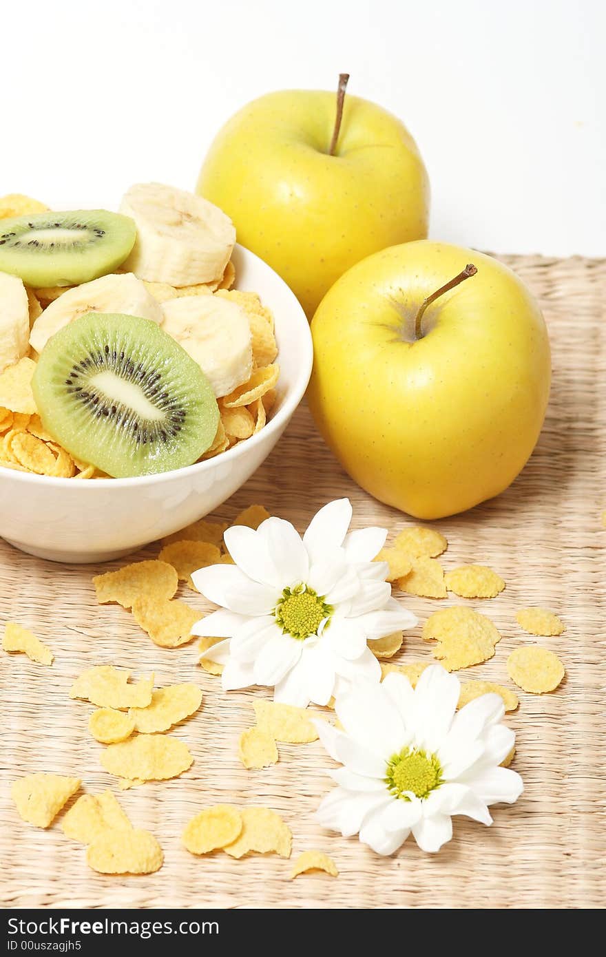 Healthy breakfast.Cornflakes and fruits with flowers. Healthy breakfast.Cornflakes and fruits with flowers.